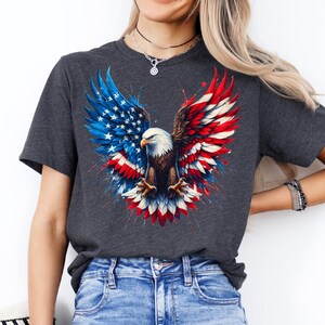 A woman wearing a gray t-shirt with an American eagle design and a necklace.