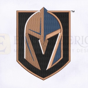 May include: A black and gold embroidered patch featuring a knight's helmet with a V-shaped design. The patch is surrounded by a black border and has a white outline. The text "TM" is in the upper right corner.