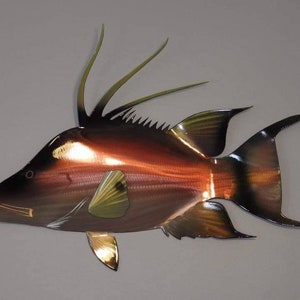 May include: A metal wall sculpture of a red and black fish with a long dorsal fin. The fish is made of metal and has a realistic appearance.