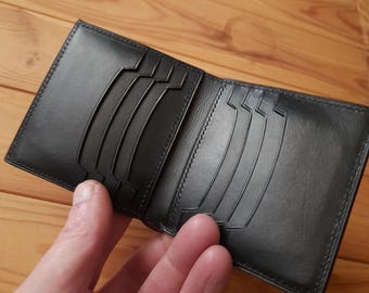 Vertical bifold wallet made of black Shell Cordovan and buttero leather.Men's luxury wallet. Buttero leather cardholder with 10 card slots