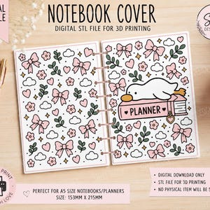 May include: A digital STL file for a 3D printed notebook cover featuring a repeating pattern of pink bows, flowers, hearts, and clouds. The right side displays a white duck resting on a pink book labeled PLANNER with a heart charm.