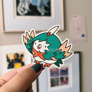 May include: A sticker featuring a cartoon bird with green hair, a red star, and a surprised expression. The bird is wearing a white and green outfit and has a peach-colored wing.