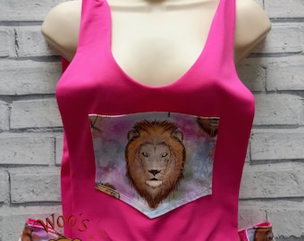 May include: Pink sleeveless top with a lion print pocket and matching lion print shorts. The top has a knotted detail at the shoulders. The shorts have a drawstring waist.