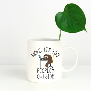 May include: White ceramic mug with a black sloth illustration and the text "NOPE, ITS TOO PEOPLEY OUTSIDE".