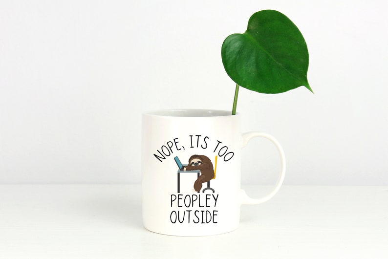 May include: White ceramic mug with a black sloth illustration and the text "NOPE, ITS TOO PEOPLEY OUTSIDE".