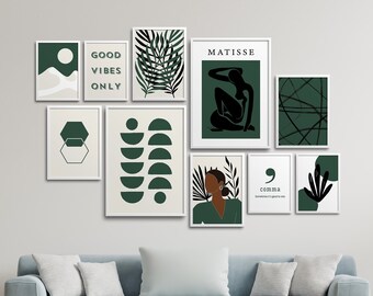 May include: A collection of framed art prints in white frames, featuring abstract designs and botanical illustrations in shades of green and white. One print reads "GOOD VIBES ONLY". The art is displayed above a light blue sofa.