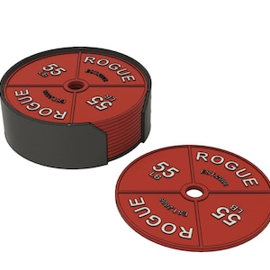 May include: A set of red weight plate coasters with the word "ROGUE" and "55 LB" printed on them. The coasters are round with a hole in the center and are stacked in a black holder. The design mimics a weightlifting plate.
