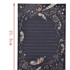 Puede incluir: Papel de papeler&iacute;a negro con detalles dorados, de 14,8 cm de ancho y 21,3 cm de alto. El dise&ntilde;o presenta plumas, estrellas, una luna y una botella. El papel tiene secciones rayadas para escribir.