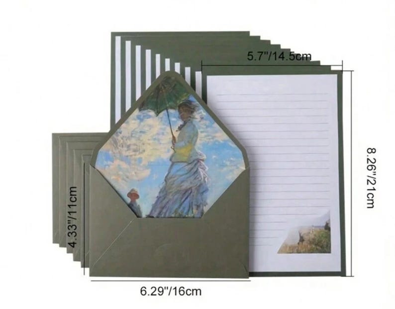 Pu&ograve; includere: Un set di 21 cm x 14,5 cm di fogli di carta da lettere rigati con una busta verde. La busta ha un'immagine stampata di una donna con un ombrello in un campo. I fogli di carta da lettere hanno un bordo a strisce verde e bianco.
