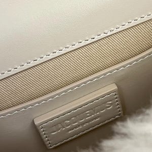 May include: A set of three ceramic mugs with a speckled, matte finish. The mugs are in shades of cream, light gray, and dark gray. Each mug has a simple, minimalist design and a rounded handle.