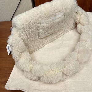 May include: A handmade wooden sign with the text "Welcome" in a playful font. The sign features a distressed white background and a dark brown border, perfect for a front door or entryway. The sign measures approximately 12 inches wide and 6 inches tall.