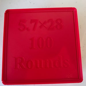 May include: Red box with the text "5.7x28 100 Rounds" embossed on the top.