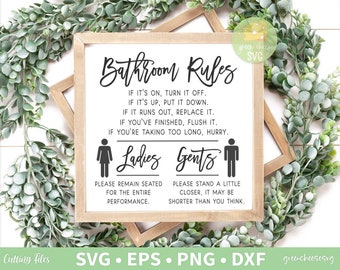 May include: A framed sign with the text "Bathroom Rules" in black script. The sign includes instructions and gendered icons for ladies and gents. The sign is surrounded by a green leafy wreath.