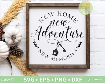 May include: A framed wooden sign with the words "NEW HOME new ADVENTURE NEW MEMORIES" in black script. A key and house graphic is in the center. The sign is surrounded by white pumpkins, pinecones, and dried wheat.