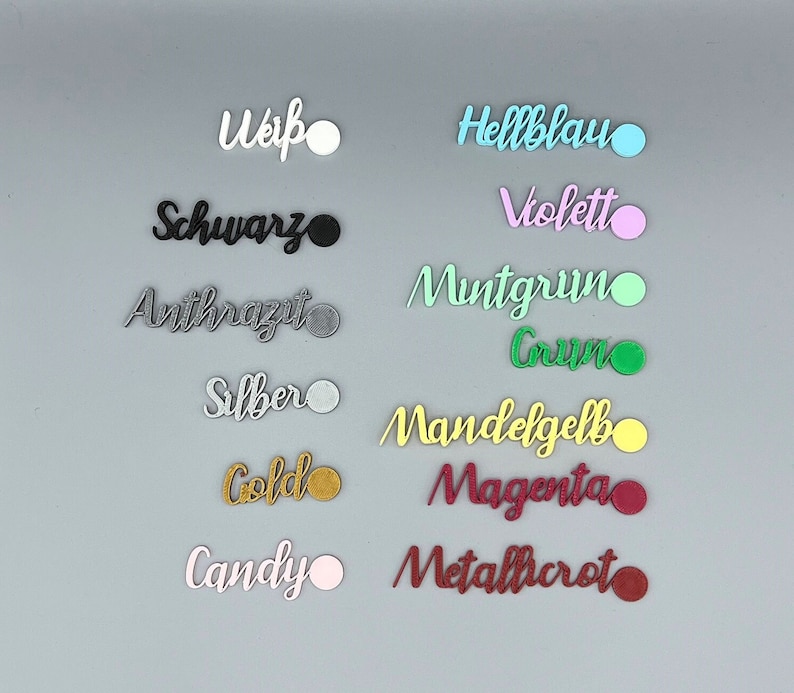 May include: A collection of color swatches with German names for each color, including Wei&szlig;, Schwarz, Anthrazit, Silber, Gold, Candy, Hellblau, Violett, Mintgr&uuml;n, Gr&uuml;n, Mandelgelb, Magenta, and Metallicrot.