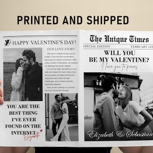 May include: A personalized newspaper-style print with black text and black and white photos. The headline reads "Happy Valentine's Day!" and "Will You Be My Valentine?" with a couple's names. The print is held by a person.
