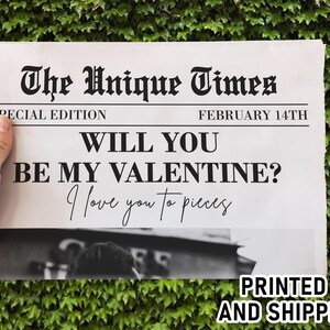 May include: A newspaper-style print with the headline "The Unique Times" and the date "February 14th." The text reads "Will you be my Valentine? I love you to pieces." The words "Printed and Shipped" are also visible.