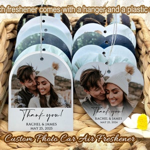 May include: Custom photo car air fresheners in arch and heart shapes featuring a printed photograph of a couple, the text Thank you!, the names Rachel & James, and the date May 25, 2025. Each freshener includes a silver hanging string and plastic wrap.