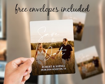 May include: Save the Date magnet with a photo of a couple in a field. The text reads "Save the Date" in white script font and "Robert & Sophia 05.08.2024 Houston, TX" in white sans-serif font.