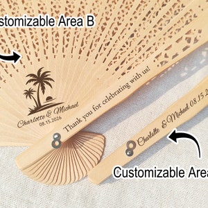 May include: A wooden hand fan with a palm tree design and the text "Charlotte & Michael 08.15.2026" on the front. The back of the fan has the text "Thank you for celebrating with us!" and "Charlotte & Michael 08.15.2026".