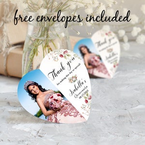 May include: Heart-shaped thank you card with a floral design and a photo of a young woman in a quincea&ntilde;era dress. The card says "Thank you for making this day so special" and "Isabella's Quincea&ntilde;era 08.17.2025".