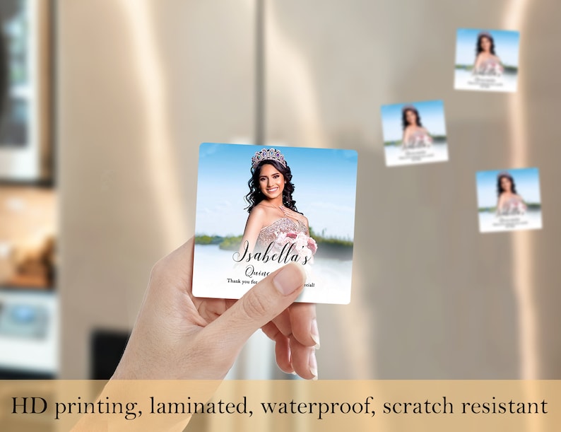 May include: A square magnet with a photo of a young woman in a quincea&ntilde;era dress. The magnet has the text "Isabella's Quince" and "Thank you for celebrating with us!" printed on it.