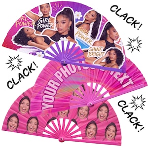 May include: Two folding hand fans with purple plastic ribs. The top fan features images of a person with the text "GIRL POWER" and "SHINE BRIGHT". The bottom fan has a pink background with repeated images of a smiling person and the text "YOUR PHOTO TEXT".