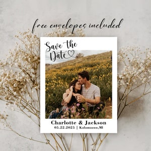 May include: Save the Date card featuring a photograph of a couple in a field of yellow flowers. The text reads "Save the Date" with a heart symbol and "Charlotte & Jackson" with the date "05.22.2025" and location "Kalamazoo, MI".