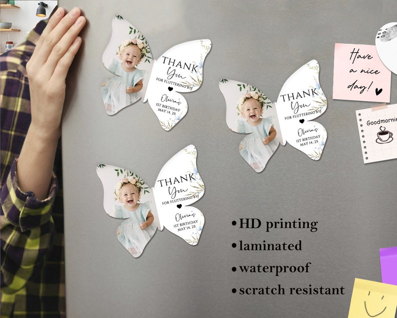 May include: Butterfly-shaped magnets featuring a baby girl's photo, floral details, and the text "THANK YOU FOR FLUTTERING BY! Olivia's 1st Birthday MAY 14, 25." These magnets are laminated, waterproof, and scratch resistant.