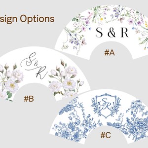 May include: Three fan-shaped designs with floral patterns and initials. The top design features purple and green flowers with "S & R" and "#A". The middle design has white roses, initials "S & R", and "#B". The bottom design is blue floral with initials "S & R" and "#C".