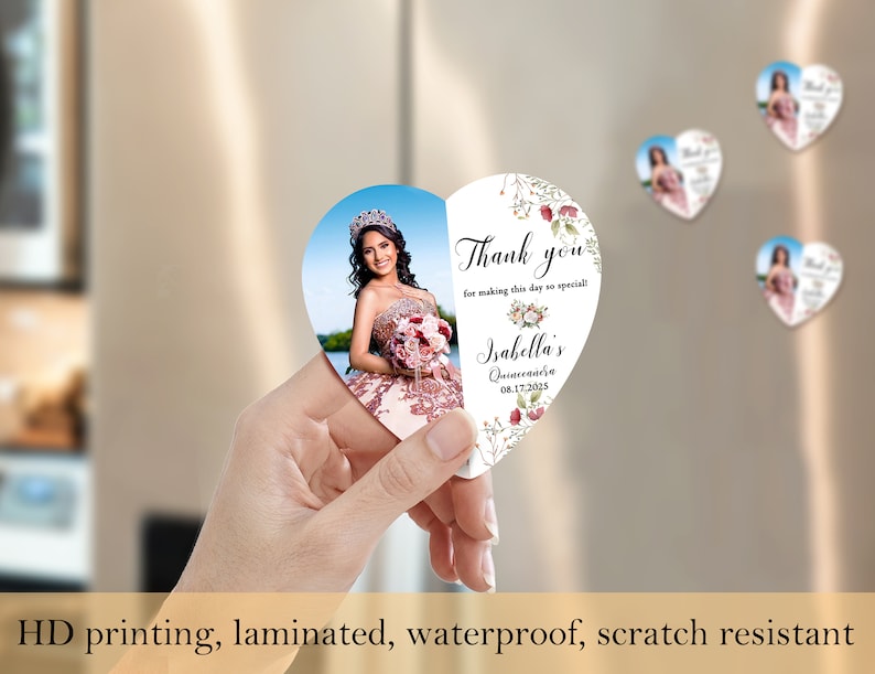 May include: Heart-shaped thank you magnet with a photo of a young woman in a quincea&ntilde;era dress. The magnet has a floral design and the text "Thank you for making this day so special! Isabella's Quincea&ntilde;era 08.17.2025".
