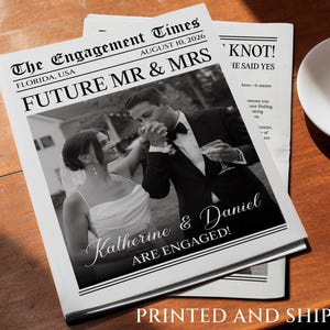 May include: A black and white newspaper announcement with the headline "The Engagement Times" and the text "Future Mr & Mrs Knot! He Said Yes". The announcement features a black and white photo of a couple, a woman in a white dress and a man in a suit, with the text "Katherine & Daniel Are Engaged!" printed below the photo.