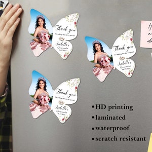 May include: Three butterfly-shaped magnets with a photo of a young woman in a quincea&ntilde;era dress. The magnets have a floral design and the text "Thank you for making this day so special Isabella's Quincea&ntilde;era 08.17.2023".