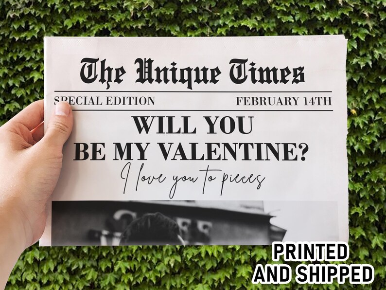 May include: A newspaper-style print with the headline "The Unique Times" and the date "February 14th." The text reads "Will you be my Valentine? I love you to pieces." The words "Printed and Shipped" are also visible.