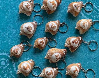 Handcrafted shell silver coastal keychain with engraved alphabets on conch shells unique personalized accessory for your keys bags or gifts