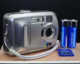 Vintage Kodak EasyShare C310 3MP CCD digital camera. Includes new AA batteries and 1GB SD card included. Tested and working lo-fi digicam.