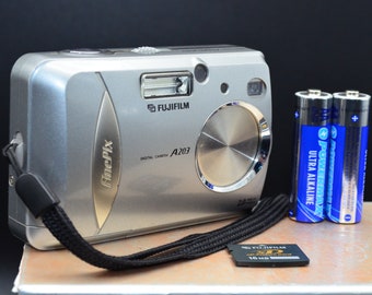 Vintage Fujifilm FinePix A203 2MP digital camera. Includes camera, fresh batteries, and a 16MB xD memory card. Fully tested and working.