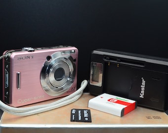 Pink Sony Cybershot DSC-W55 7MP digital camera with new battery and charger. Fully tested and working. 4Gb Sony Memory stick pro duo option.