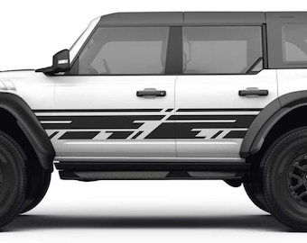 May include: A white Ford Bronco with black side stripes and black wheels. The vehicle is shown in profile view.