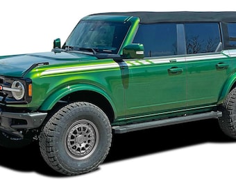 May include: A green Ford Bronco with black accents and white and green stripes on the side. The vehicle has a black roof and black wheels with a gray rim.