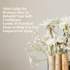 May include: A still-life image featuring a glass vase filled with white flowers and delicate baby's breath. The vase holds rolled paper tubes with handwritten text. Text on the left reads: "Mini Guide for Women: How to Rebuild Your Self-Confidence."