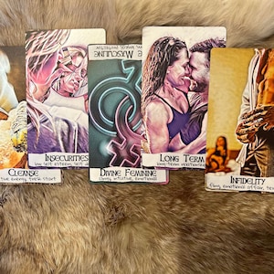 May include: Five tarot cards with colorful illustrations and handwritten text. The cards are laid out on a brown furry surface. The text on the cards reads: "Insecurities, low self esteem, self doubt", "Cleanse, the energy, fresh start", "Divine Feminine, clingy, intuitive, emotional", "Long Term, long-term relationship", "Infidelity, fling, emotional affair, text".