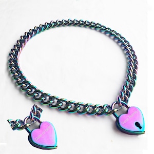 May include: A rainbow iridescent chain necklace with a heart-shaped padlock. The padlock has the text "Your Name" engraved on it. A second heart-shaped padlock with the text "Date of Birth" is also shown.