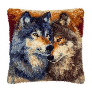 May include: Square decorative pillow featuring a detailed image of two wolves. The wolves are depicted with blue, brown, and tan fur, with a red and brown background. The pillow has a textured, woven appearance.