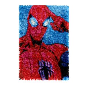 May include: A red and blue rug with a close-up image of Spider-Man's face. The rug is made of yarn and has a fuzzy texture.