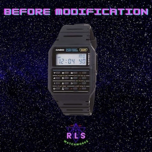 May include: A black Casio calculator watch with a digital display showing the time as 12:04 and the date as MO 40. The watch has a black resin band and a black case. The watch has a calculator function and a water resistance rating of WR.
