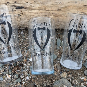 May include: Three clear glass beer mugs with black tuxedo designs and text. The mugs read "James Groom", "Chris Usher", and "Best Man".