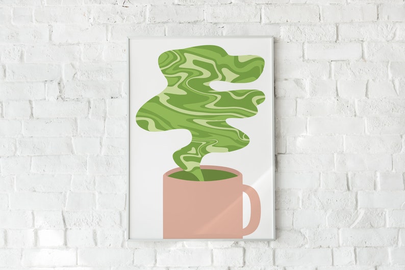 May include: A framed art print featuring a pink mug with green liquid and a swirling green vapor design. The artwork is set against a white background and a white brick wall.