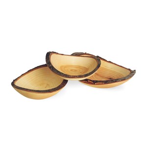 May include: Three wooden bowls with bark edges. The bowls are nested together and are made of light wood with a natural finish.