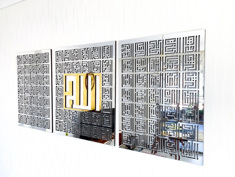 May include: Three silver metal wall art pieces with a geometric pattern. The center piece features the word "Allah" in gold.